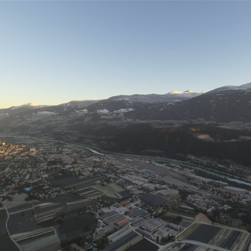 Panoramablick auf eine ausgedehnte Tallandschaft mit städtischer Bebauung vor einer majestätischen, schneebedeckten Bergkette.